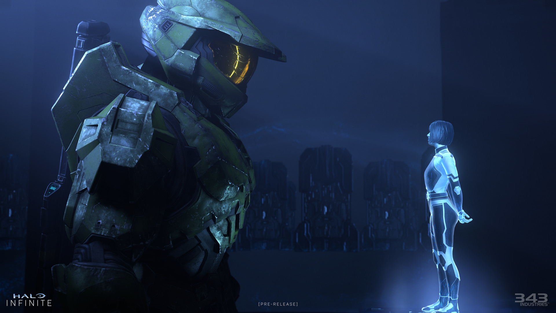 Scène de Halo Infinite. Master Chief se tient devant une figure holographique d'IA dans une pièce bleue.