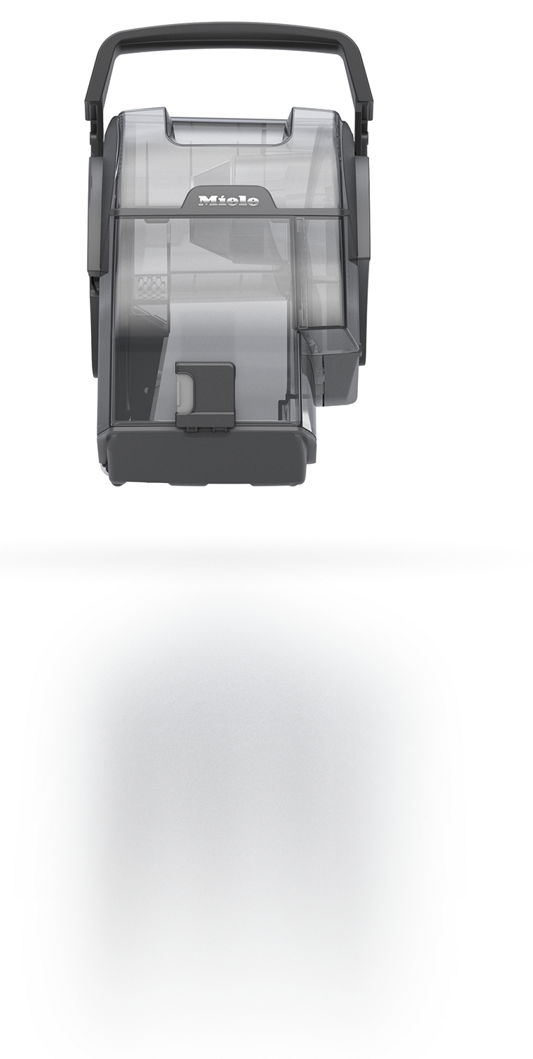 A transparent vacuum cleaner dust container with handle. It's black, and partially empty with shadow.