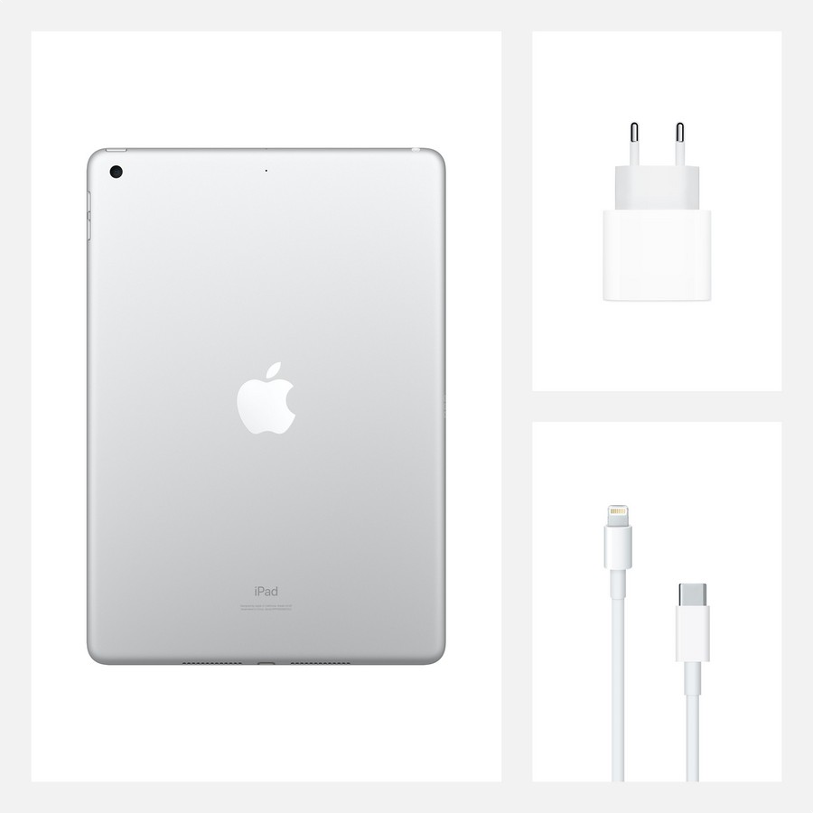 Un iPad plateado con cargador, cable y adaptador de corriente.