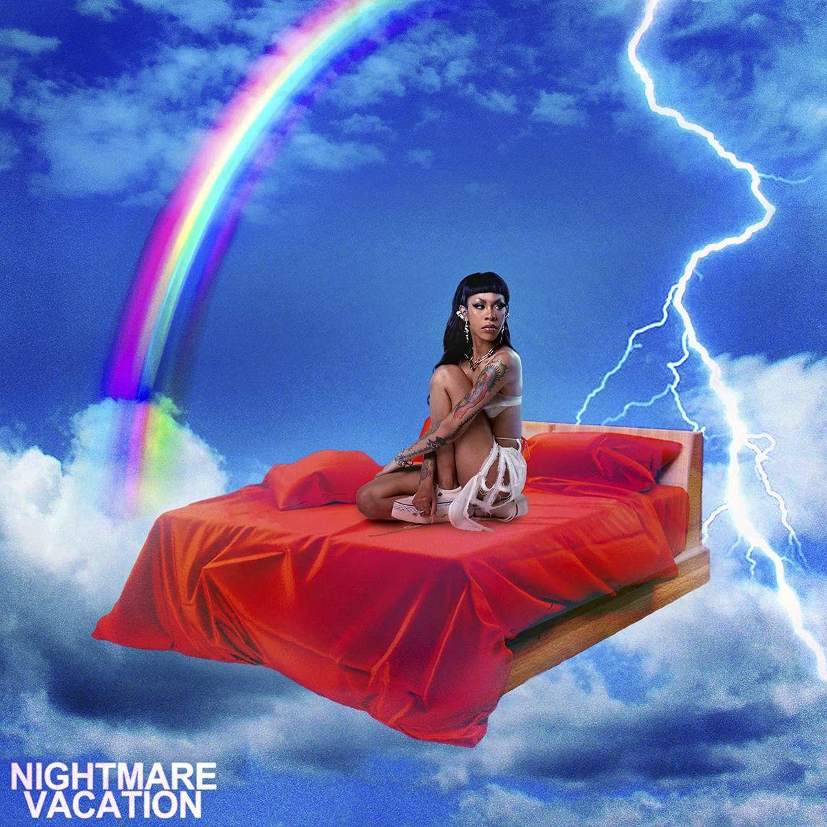 Nő az ágyon az égen. Szivárvány és villám. 'Nightmare Vacation' cím. Kék ég.