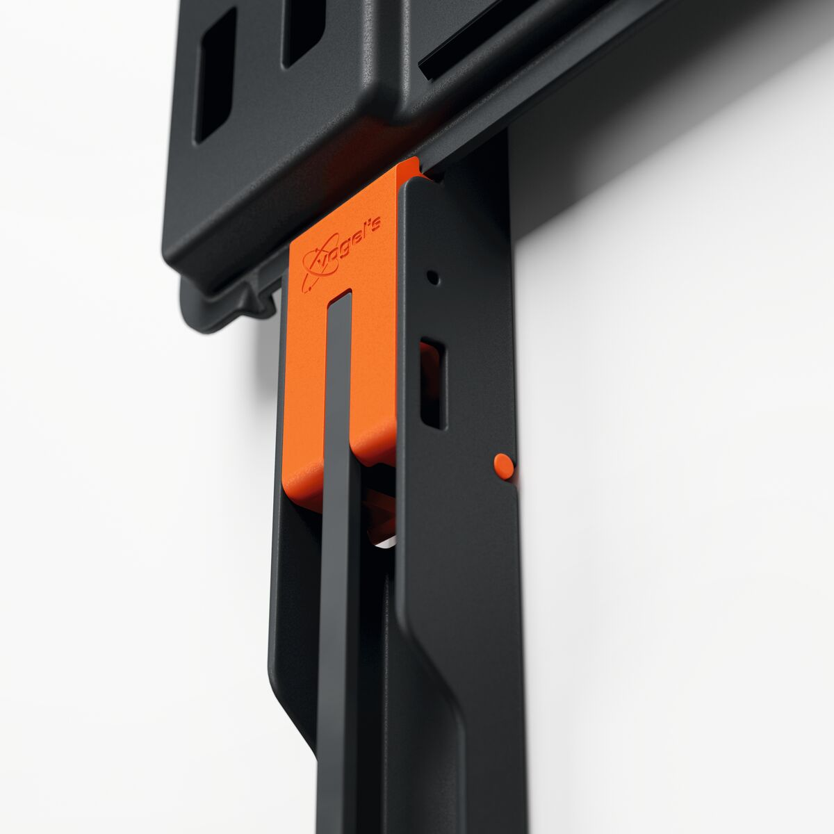 Close-up of a black and orange TV mounting bracket.