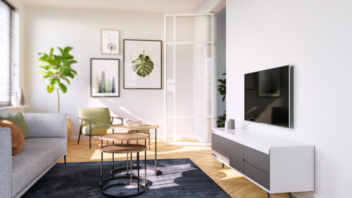 Living room with sofa, coffee tables, TV on the wall, and plants.
