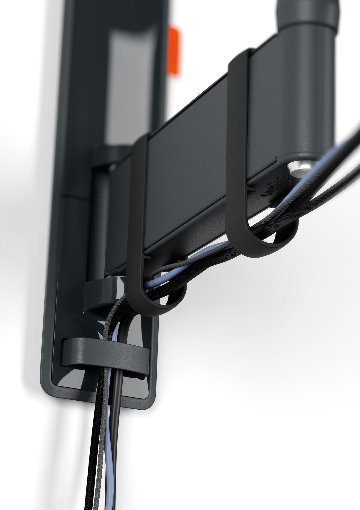 Black cable TV bracket with black cables against white wall.