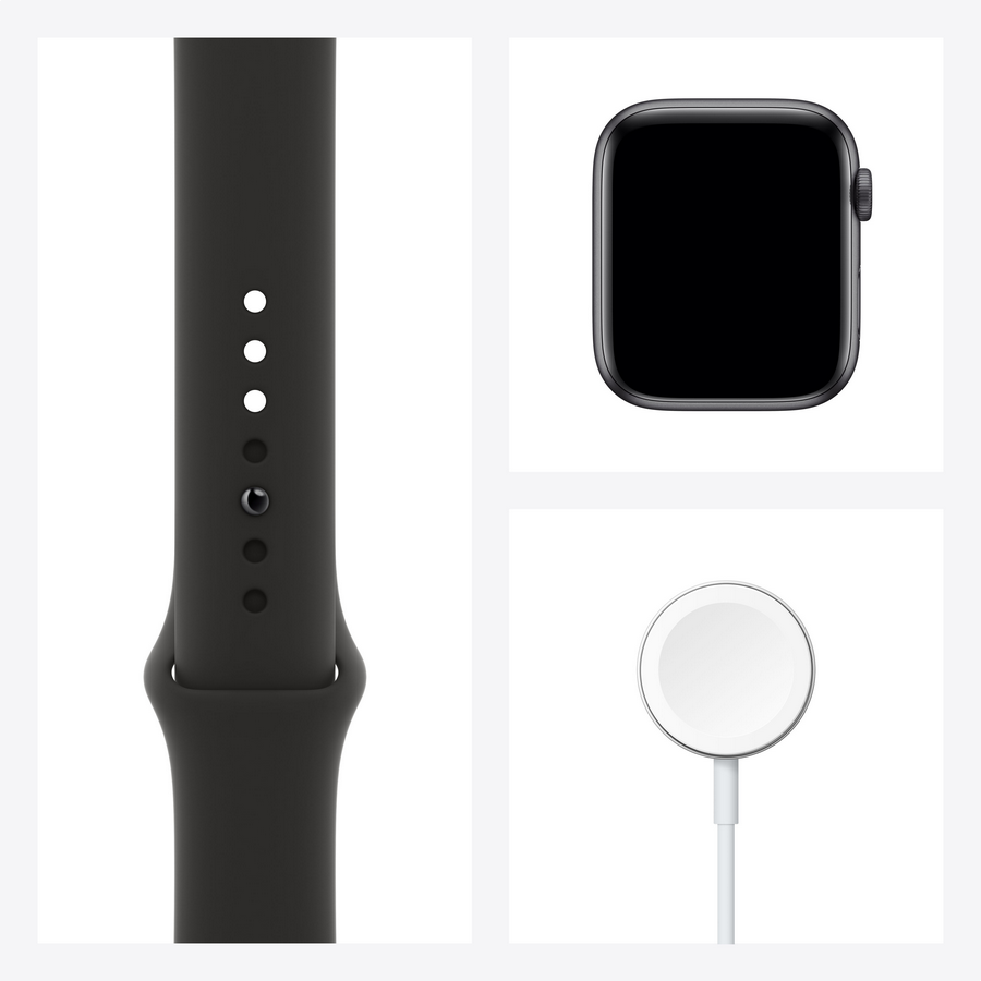 Una correa de Apple Watch, la esfera del reloj y el disco de carga sobre un fondo blanco.
