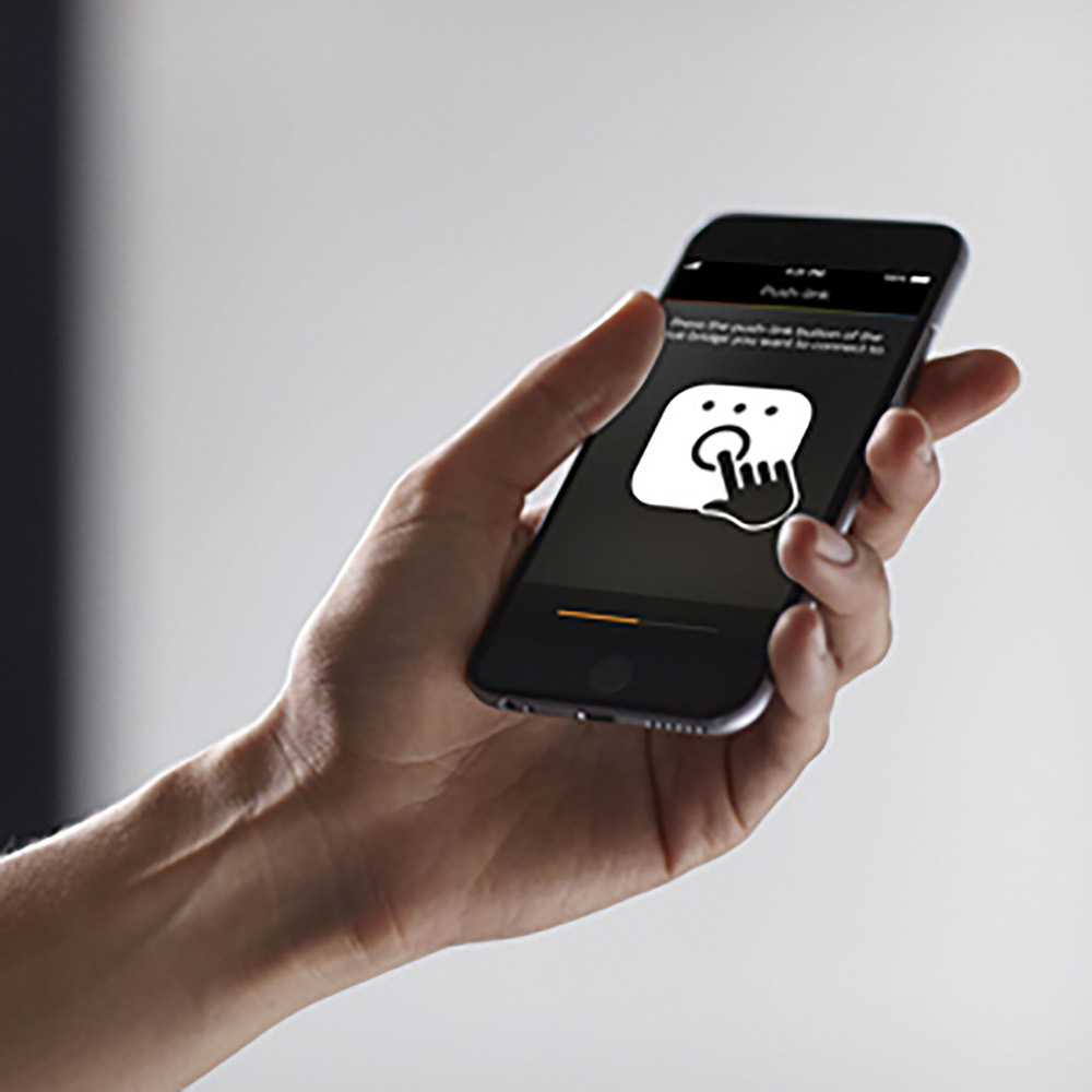A hand holding a phone, displaying a touch-screen icon.