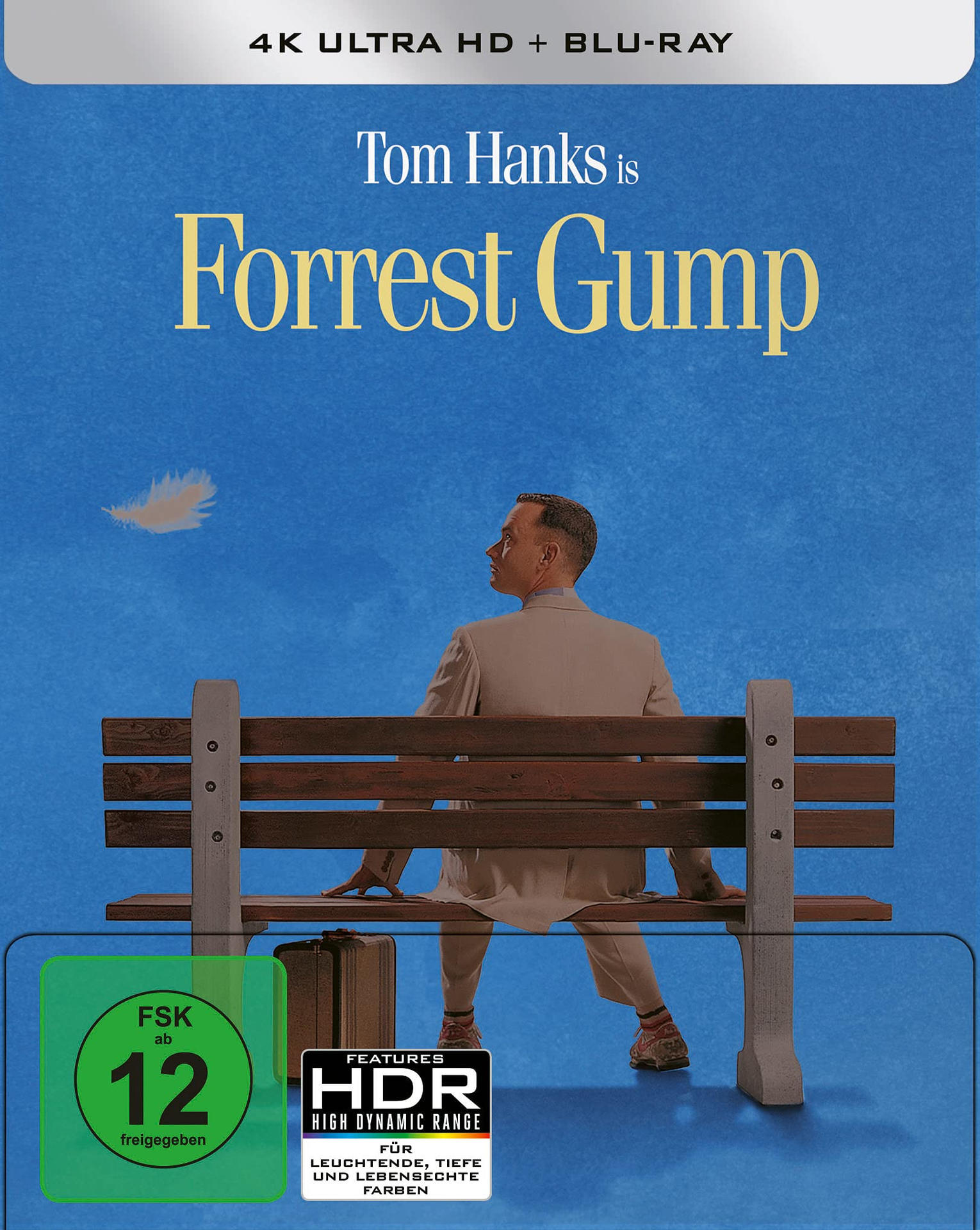 Forrest Gump Filmcover. Tom Hanks sitzt auf einer Bank. Blauer Hintergrund. Weißer Feder.
