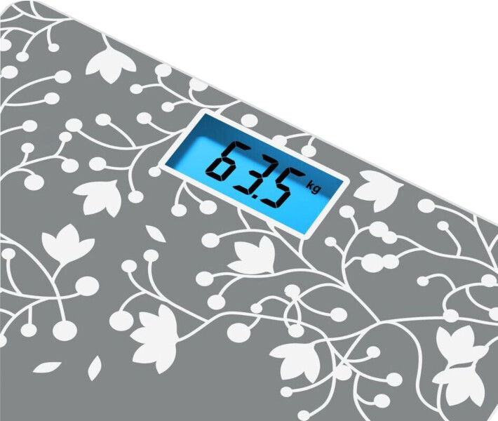 Digitális mérleg 63,5 kg-ot mutat, virágmintás.