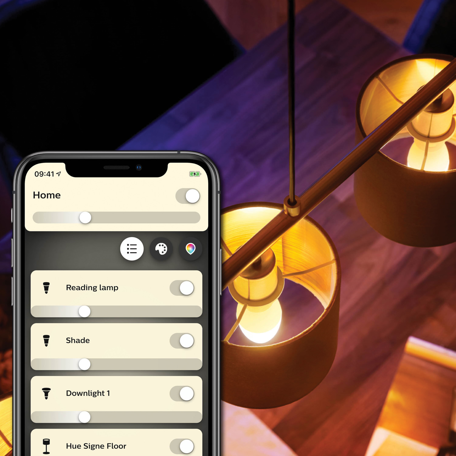 Smartphone showing smart home controls near a hanging lamp. Dark background.
