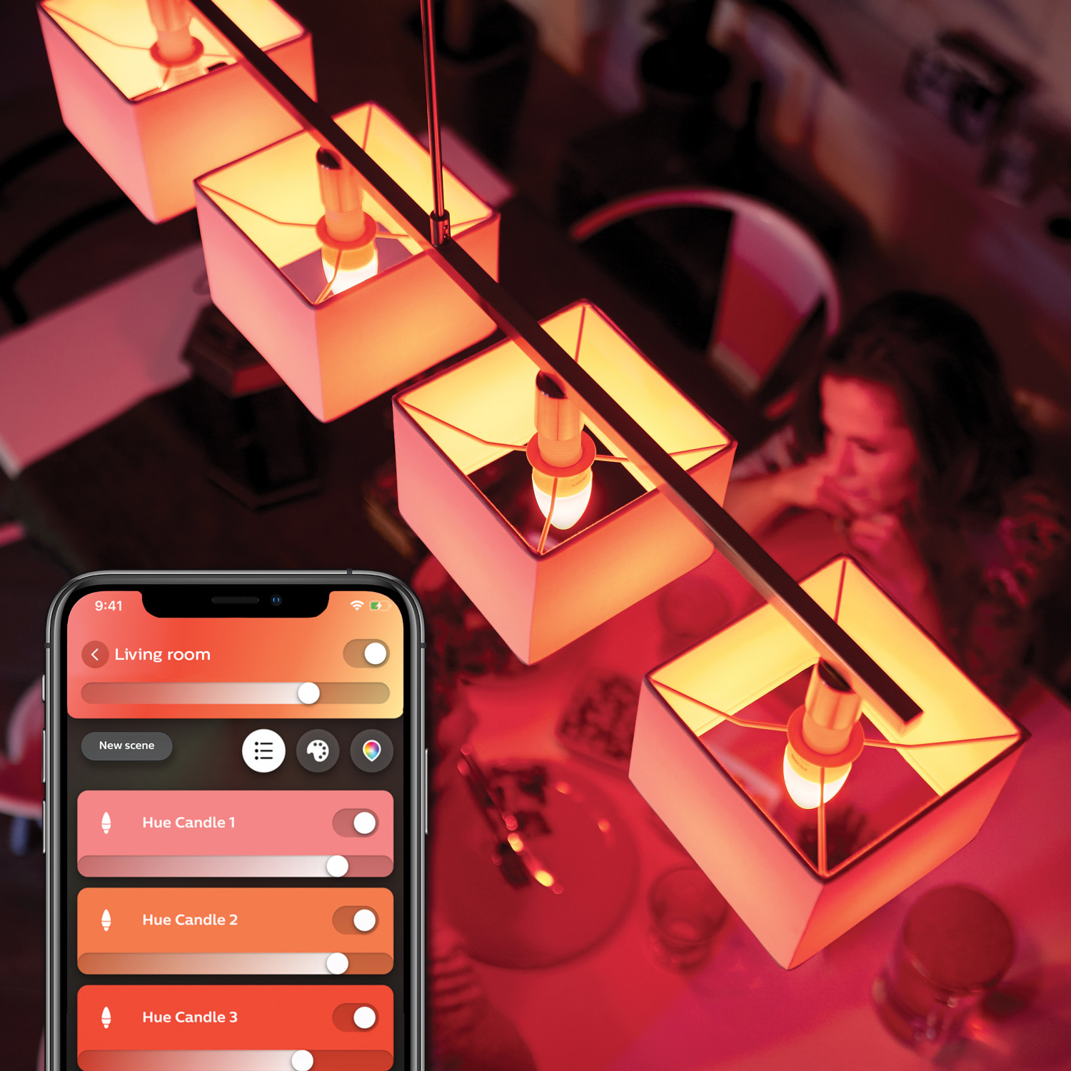 A smartphone displays a smart home app, controlling a pendant light with square shades.
