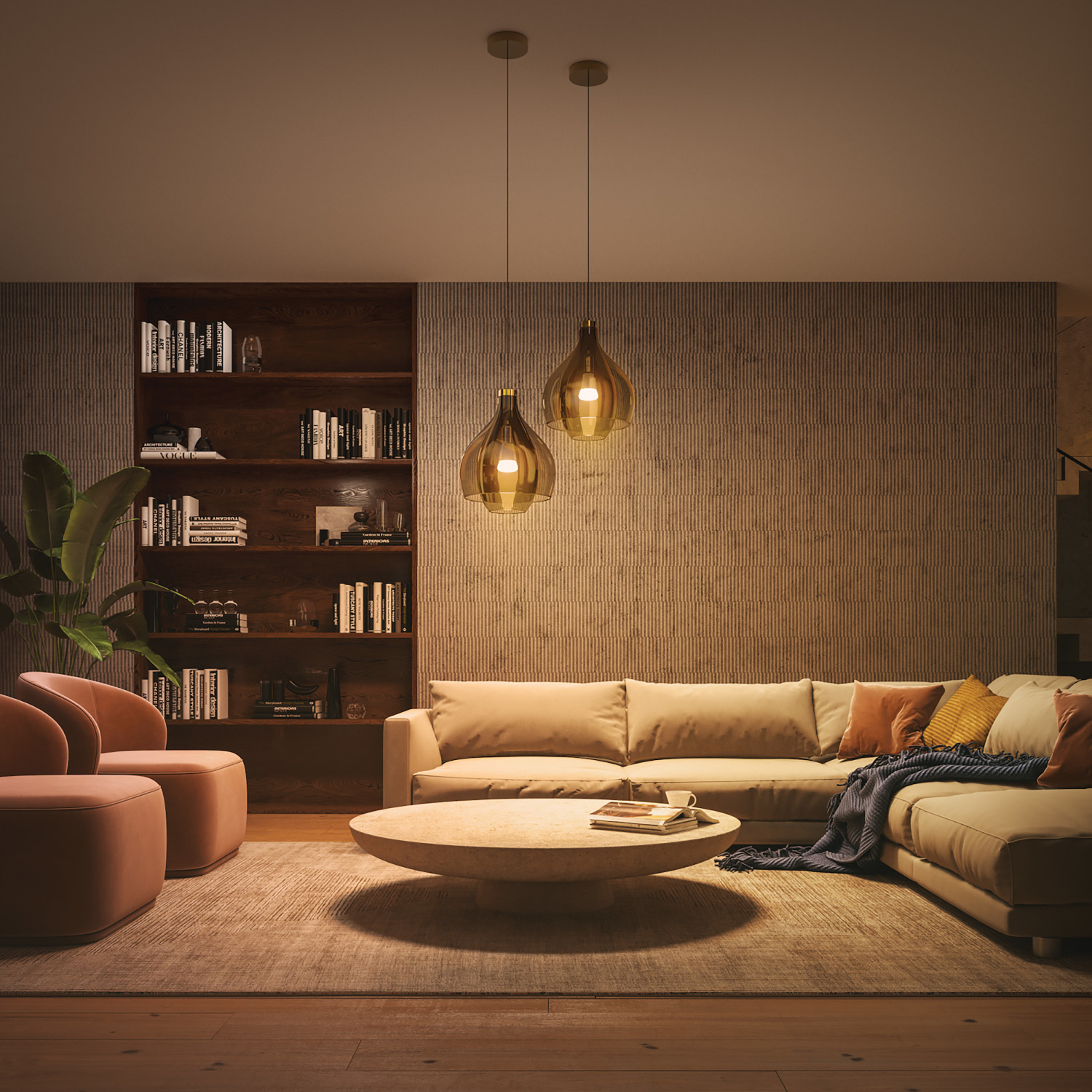 Living room with beige sofa, wooden bookshelf, and two hanging lights. Warm lighting creates a cozy atmosphere.