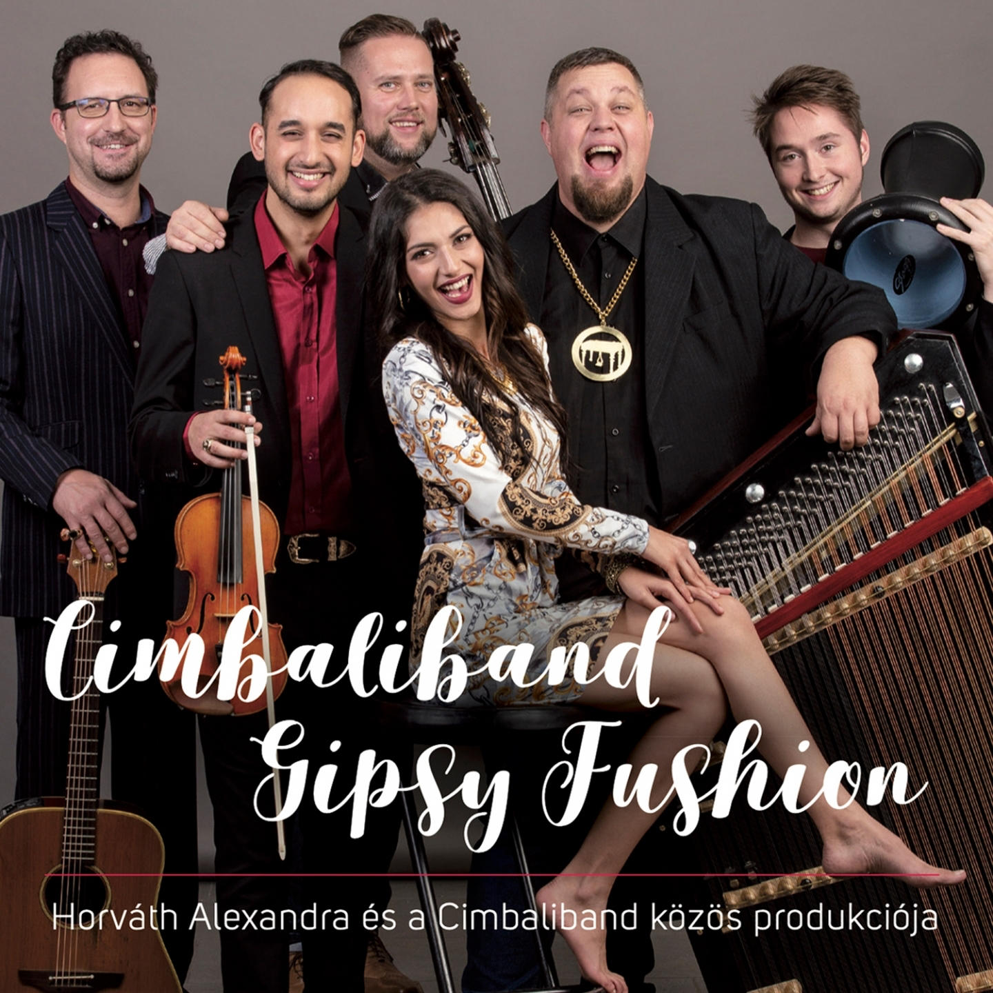 Zenei együttes portréja. Hét ember, köztük egy nő pózol. Szöveg: Cimbaliband Gipsy Fushion.