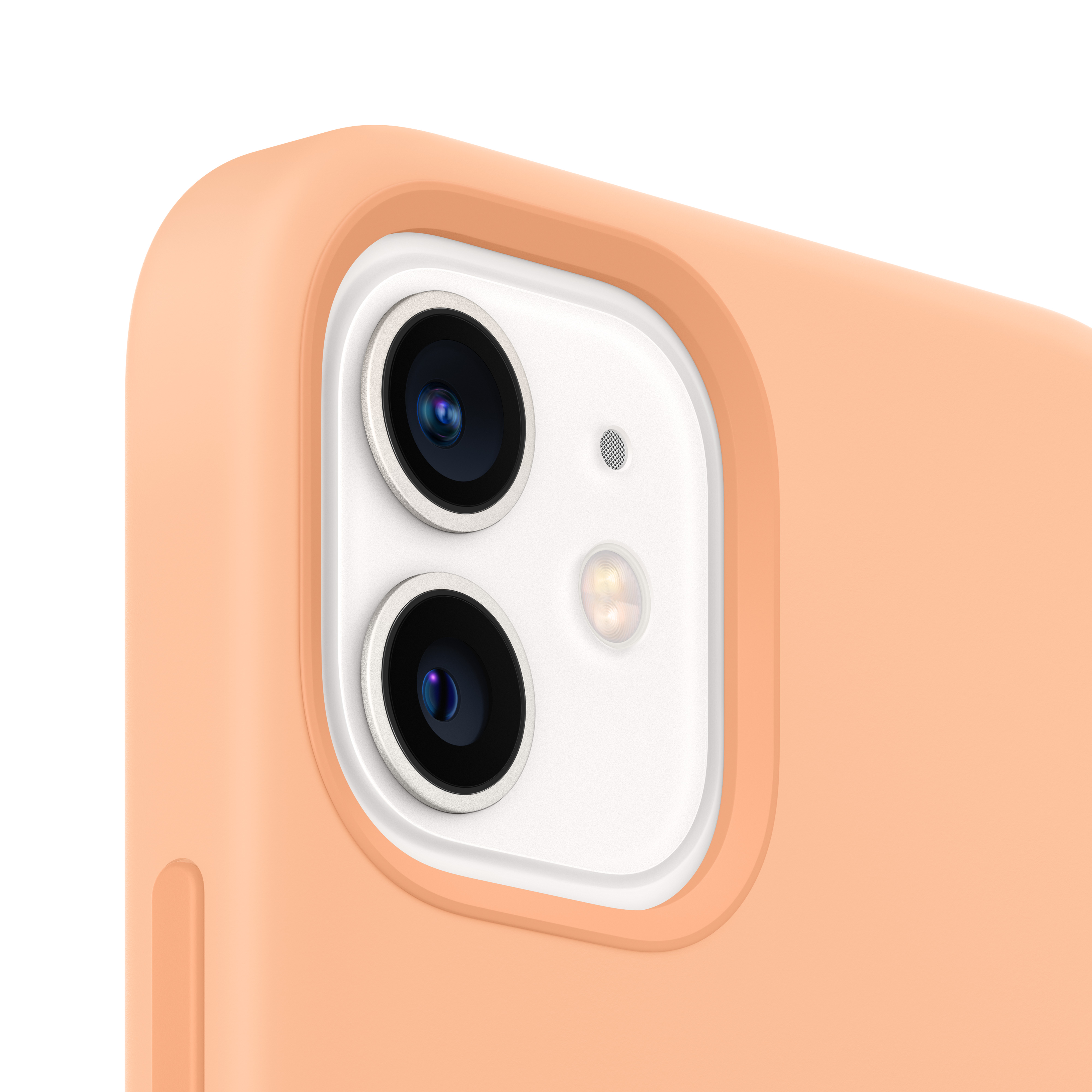 Primer plano del módulo de cámara de un teléfono, con dos lentes y flash, en carcasa melocotón.