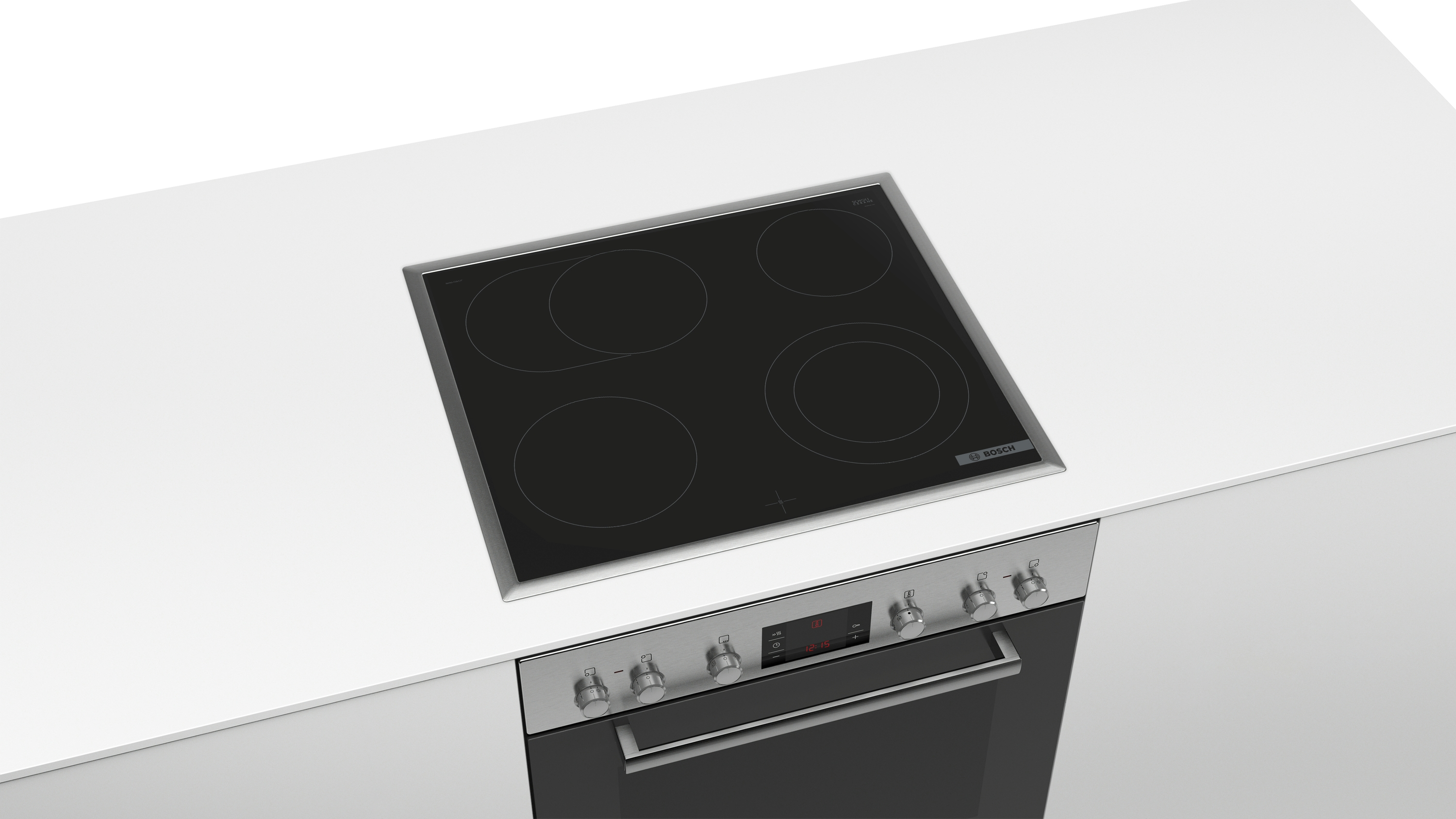 Ein schwarzer, eingebauter Herd auf einer weißen Arbeitsplatte, darunter ein Edelstahl-Backofen.