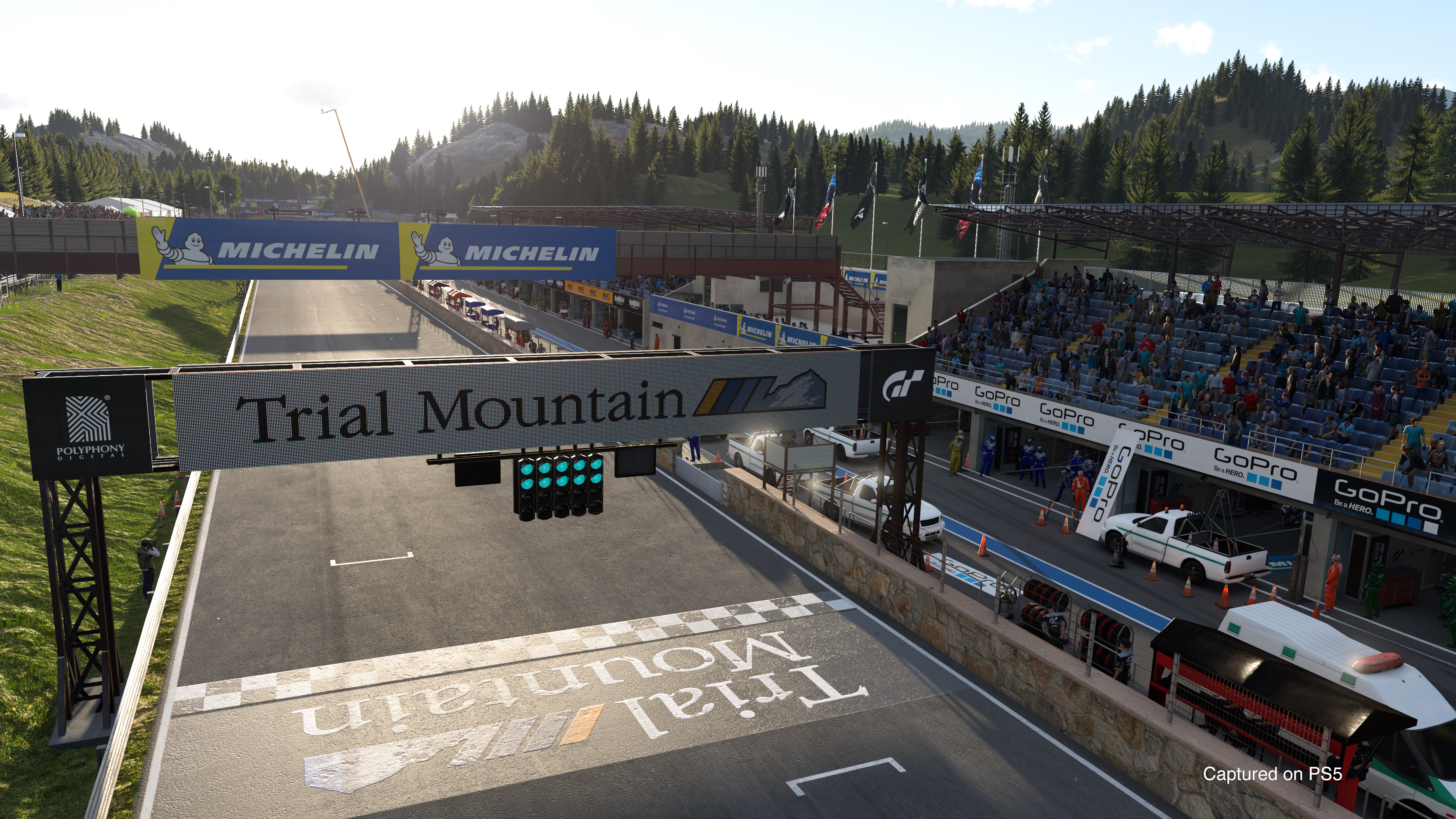 Race track with the Trial Mountain sign, spectators, and a start/finish line.