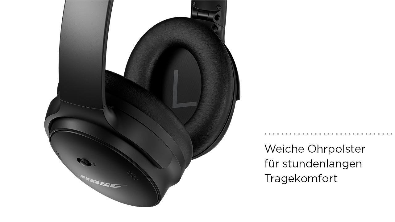 Schwarze Bose-Kopfhörer, mit Nahaufnahme des Ohrmuschels und Text auf Deutsch.