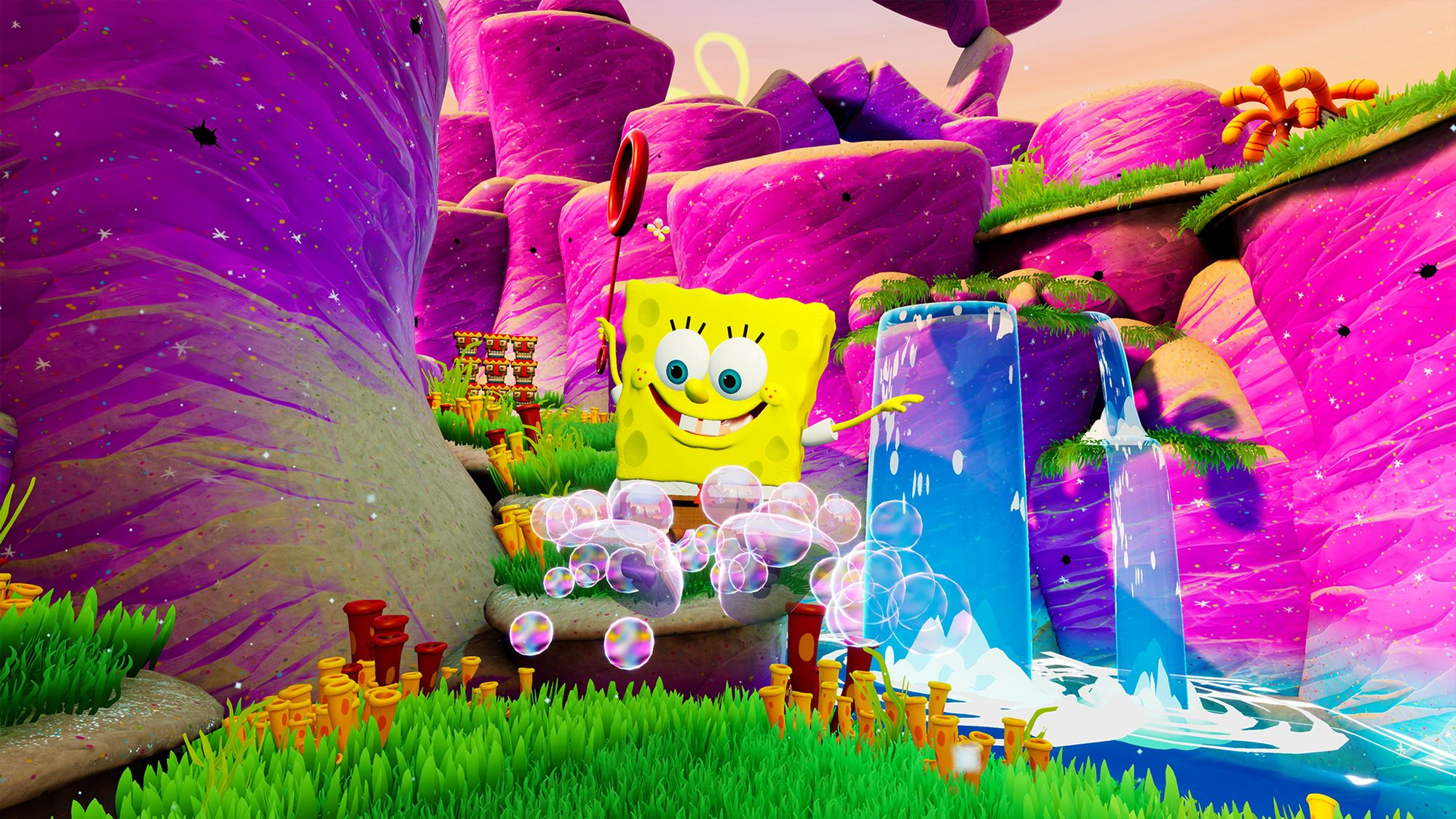 SpongeBob mit Blasen in einer bunten, cartoonartigen Landschaft mit Wasserfällen und Felsformationen.