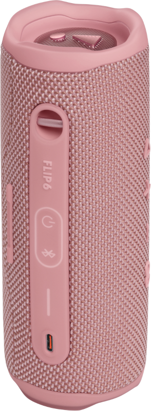 Enceinte rose JBL Flip 6. Comprend des boutons, des ports et un logo. L'enceinte a une surface texturée.