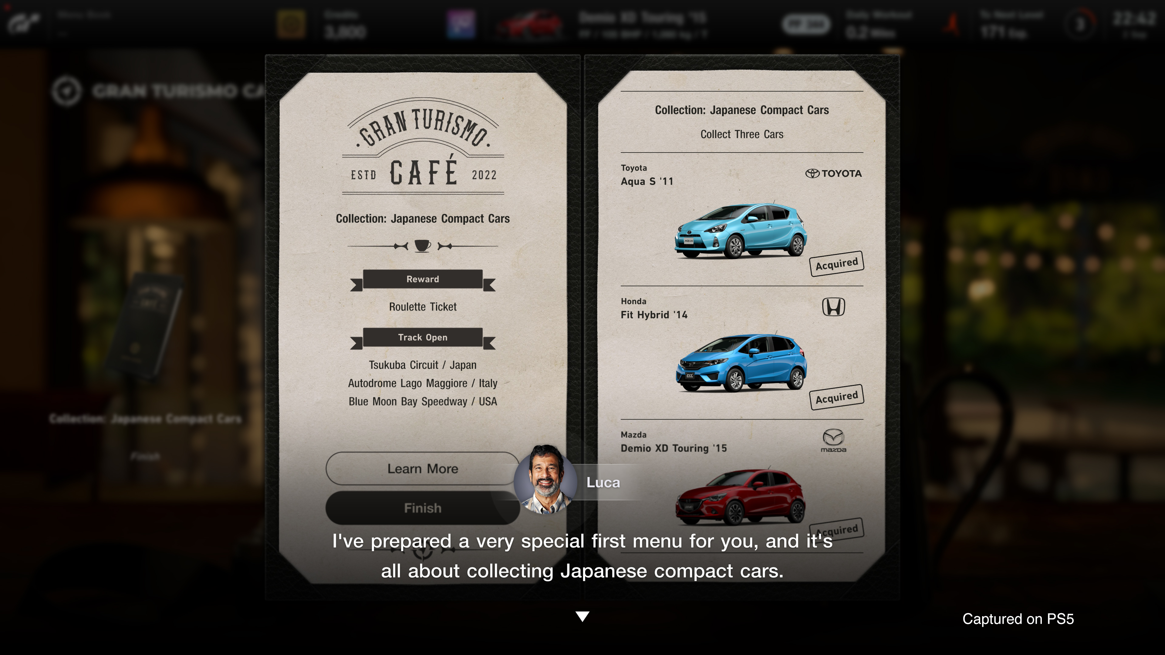 Ein Gran Turismo Cafe-Bildschirm zeigt japanische Kompaktwagen, darunter Toyota Aqua, Honda Fit und Mazda.