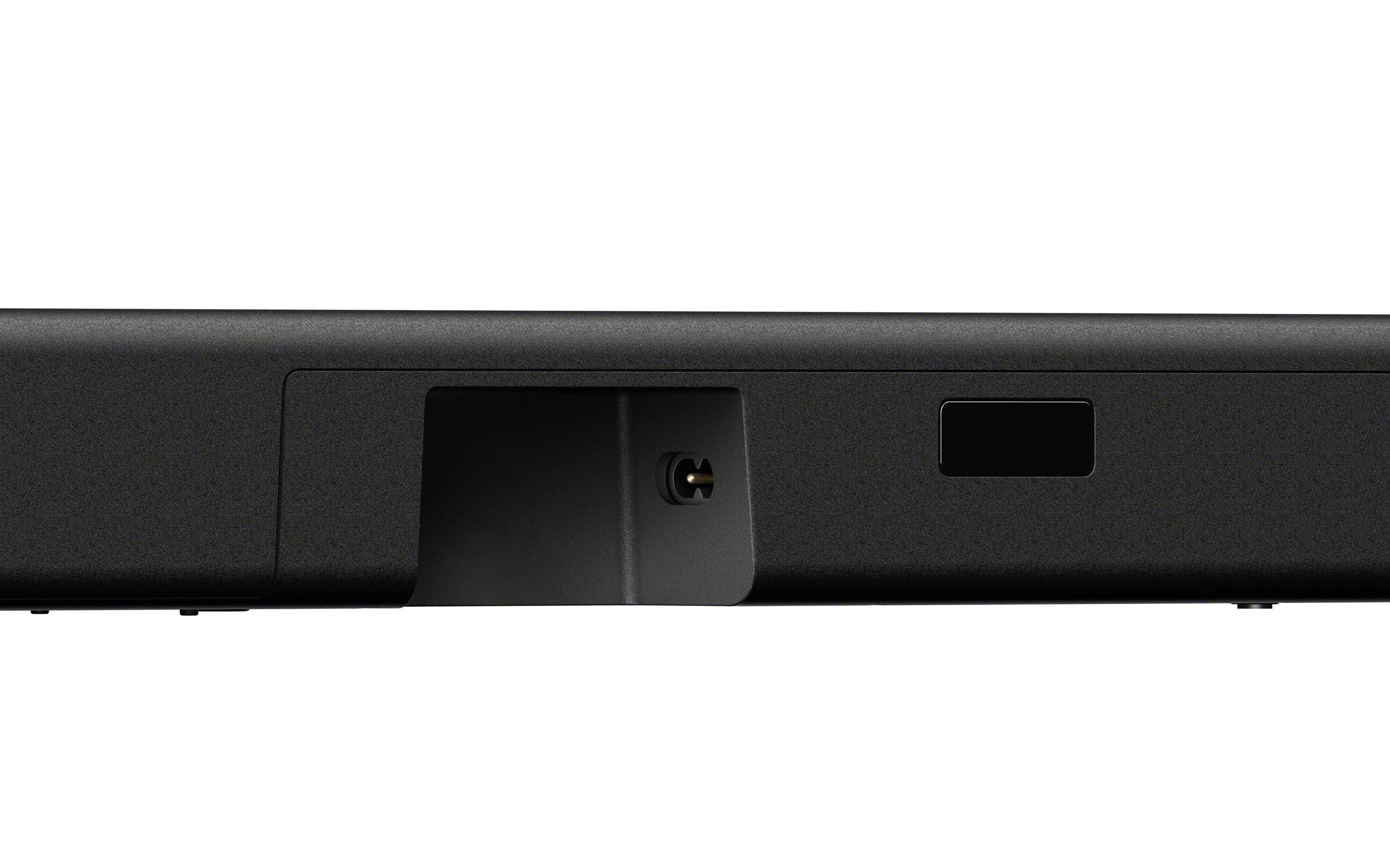 Nahaufnahme einer schwarzen Soundbar mit einem vertieften Bereich, der einen Anschluss und einen kleinen Port enthält.