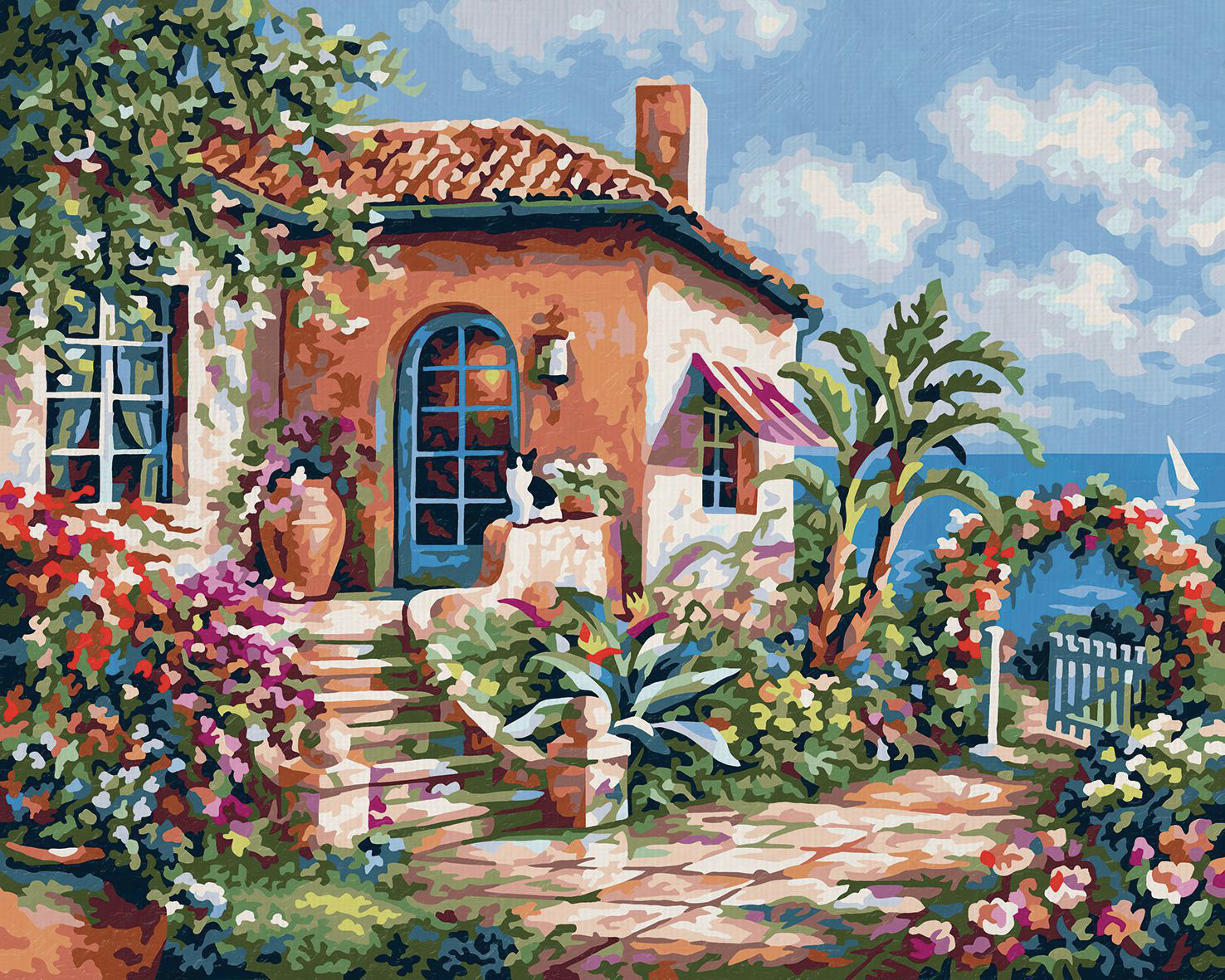 Ein Haus mit Fliesen auf dem Dach, umgeben von Blumen, mit dem Meer im Hintergrund.
