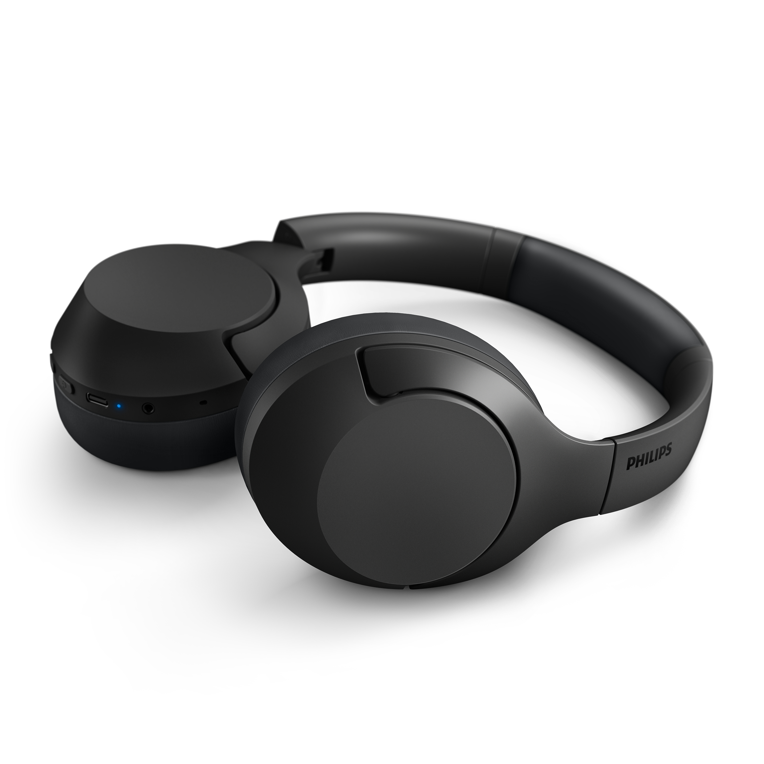 Schwarze Over-Ear-Kopfhörer. Die Kopfhörer liegen auf einer weißen Oberfläche.