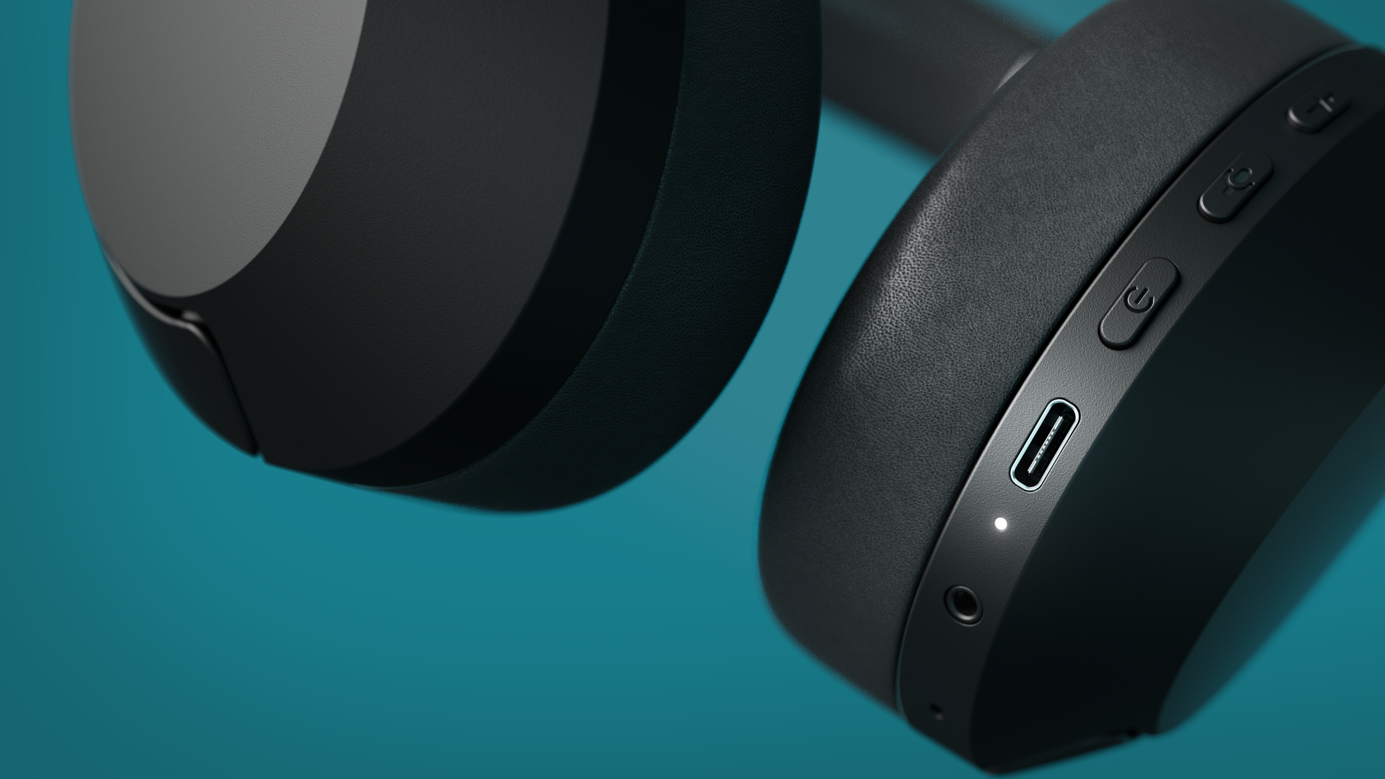 Nahaufnahme schwarzer Kopfhörer, Power-Taste, USB-C-Anschluss und Aux-Anschluss.