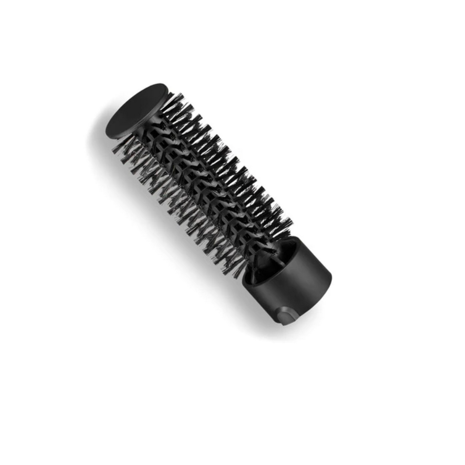 Cepillo negro para peinar el cabello con cerdas, inclinado sobre una superficie blanca.