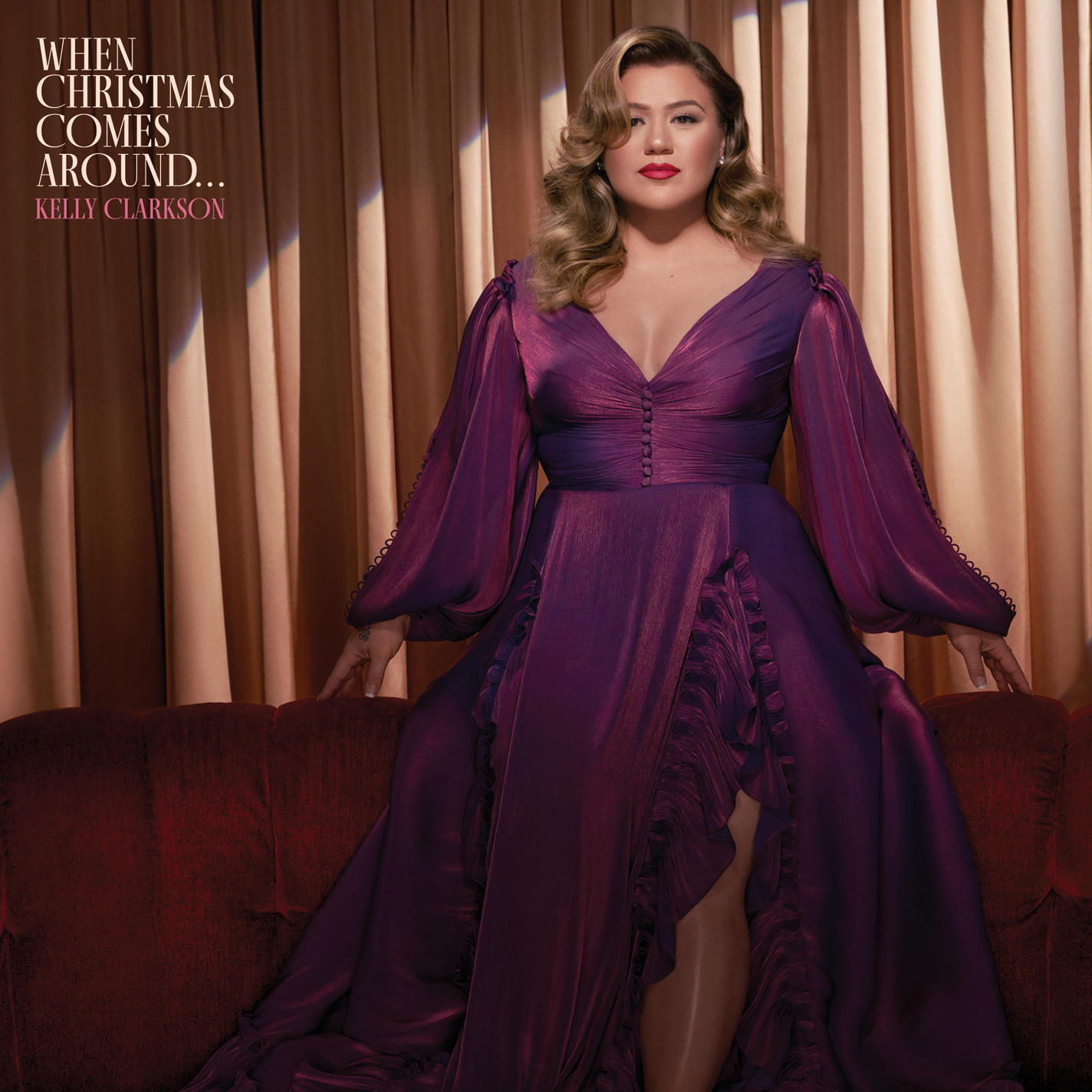 Kelly Clarkson album borítója. Lila ruhában ül a kanapén. A cím: 'When Christmas Comes Around'.