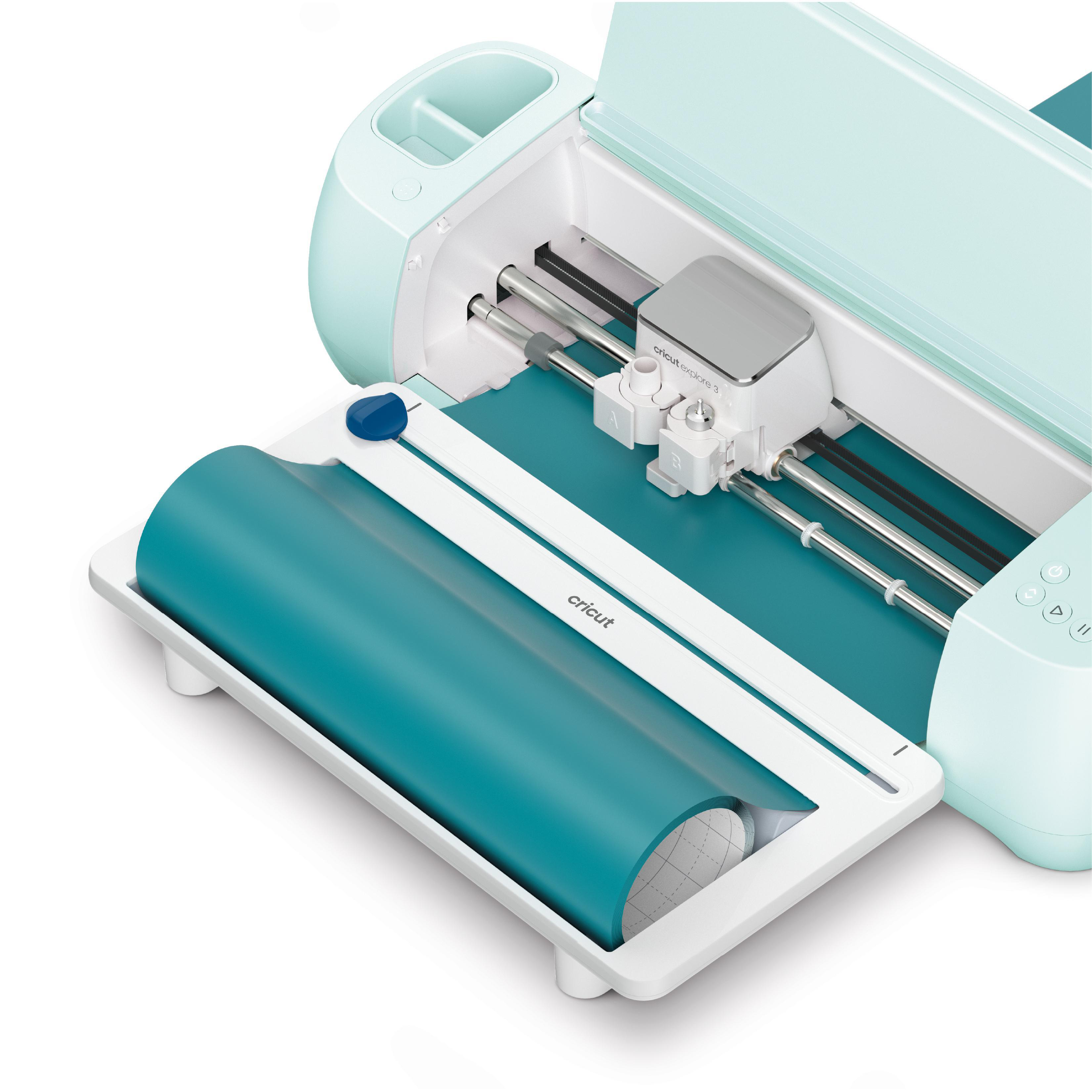 Eine türkisfarbene Cricut Explore 3 Maschine mit einer Rolle türkisfarbenem Material. Die Maschine ist offen und betriebsbereit.
