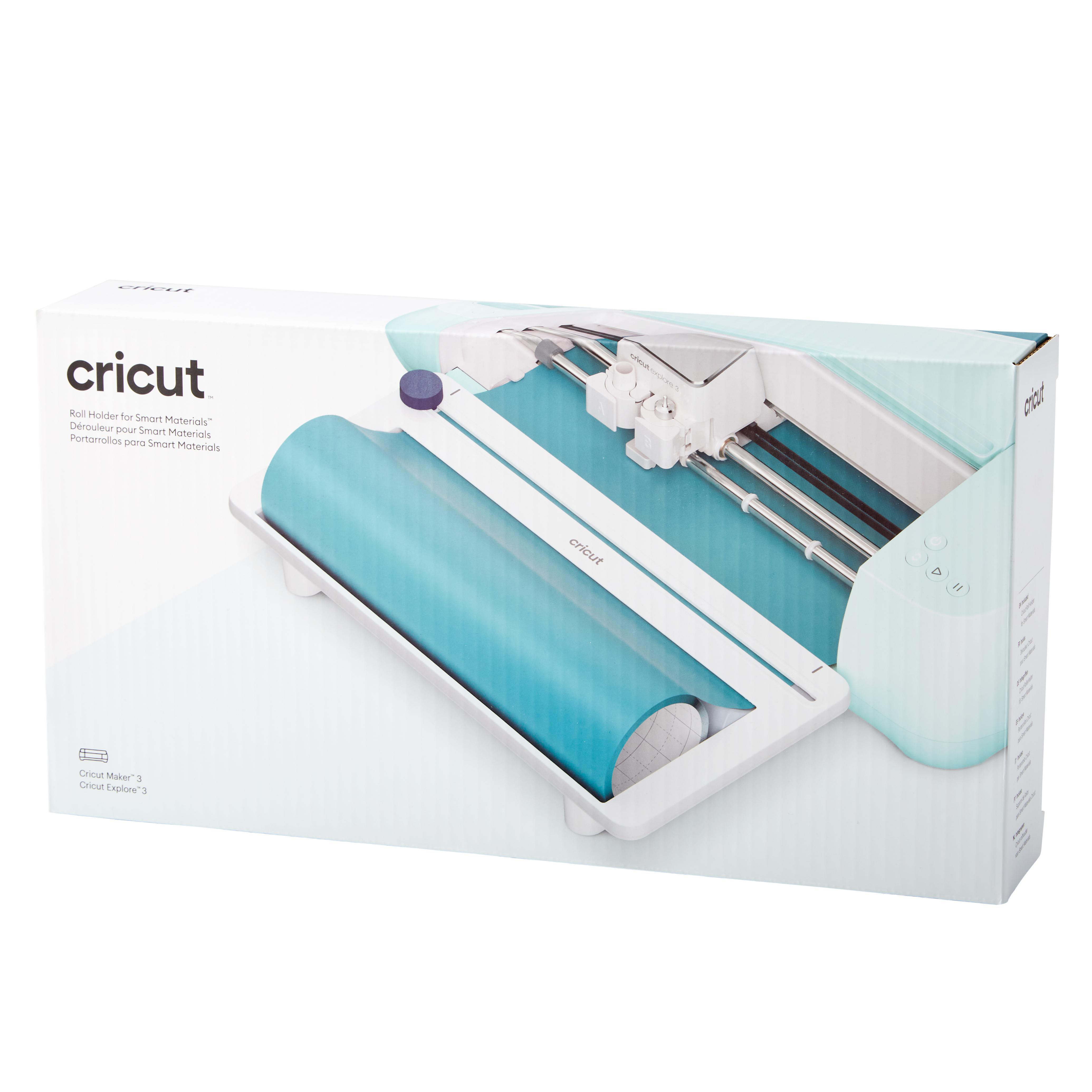 Ein Cricut-Rollenhalter in seiner Box. Es ist weiß und blaugrün. Die Box zeigt das Produkt.