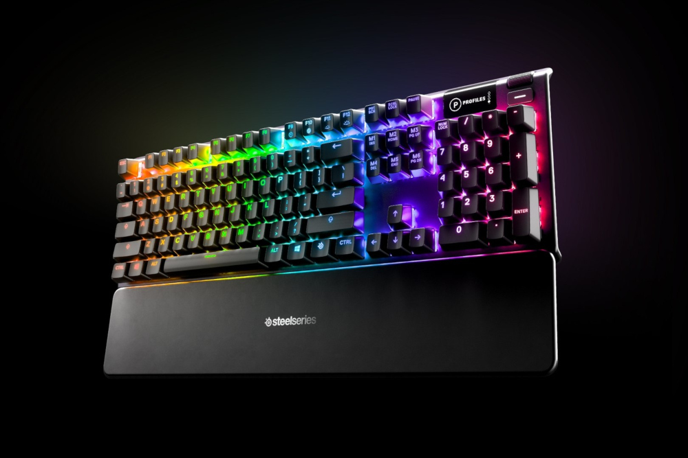 A colorful backlit mechanical keyboard on a black background. It has a wrist rest.