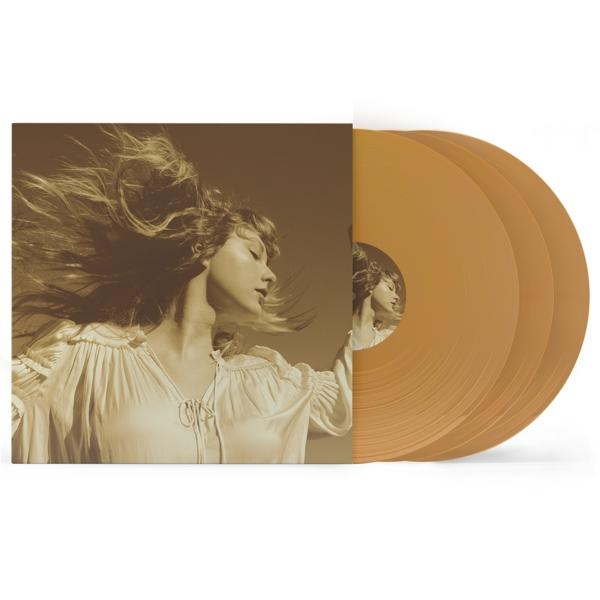Frau auf goldenem Vinyl-Albumcover mit drei goldenen Schallplatten auf weißem Hintergrund. Album ist offen.