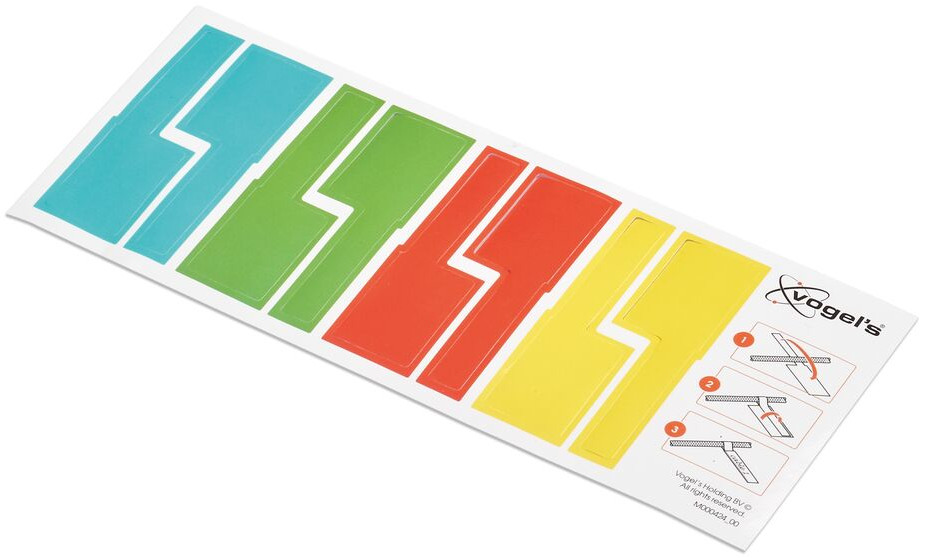 Rechthoekige stickers in blauw, groen, rood en geel, met instructies op de zijkant.