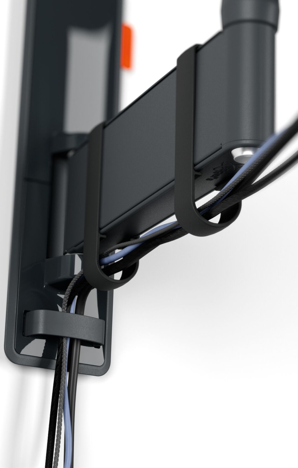 Close up of cables and a black device attached to the wall.