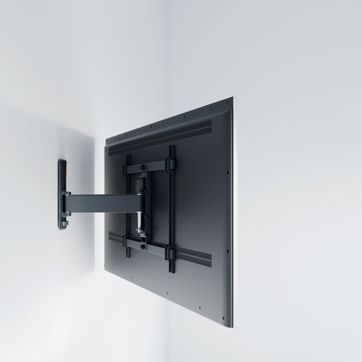 A TV mounted on a wall, with a black bracket and back, on a white wall.