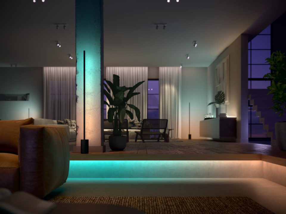 A modern living room with a floor lamp, a sofa, and a large window with a night view.