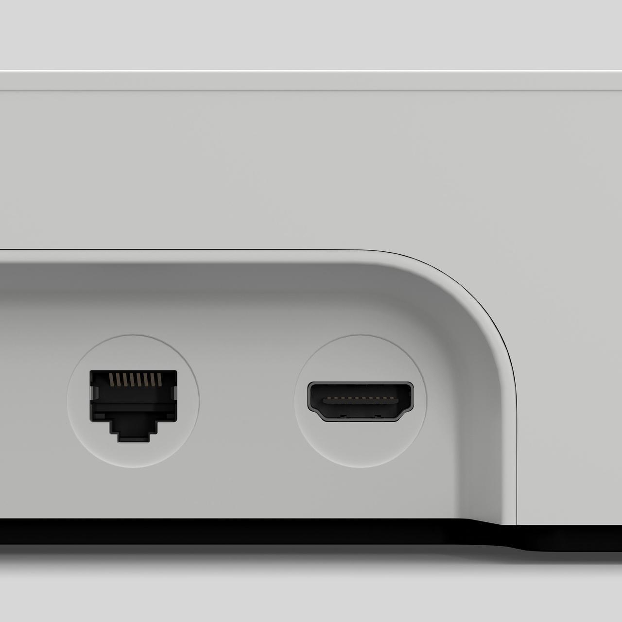 Nahaufnahme der Rückseite eines weißen Geräts mit Anschlüssen. Ethernet- und HDMI-Anschlüsse sichtbar.