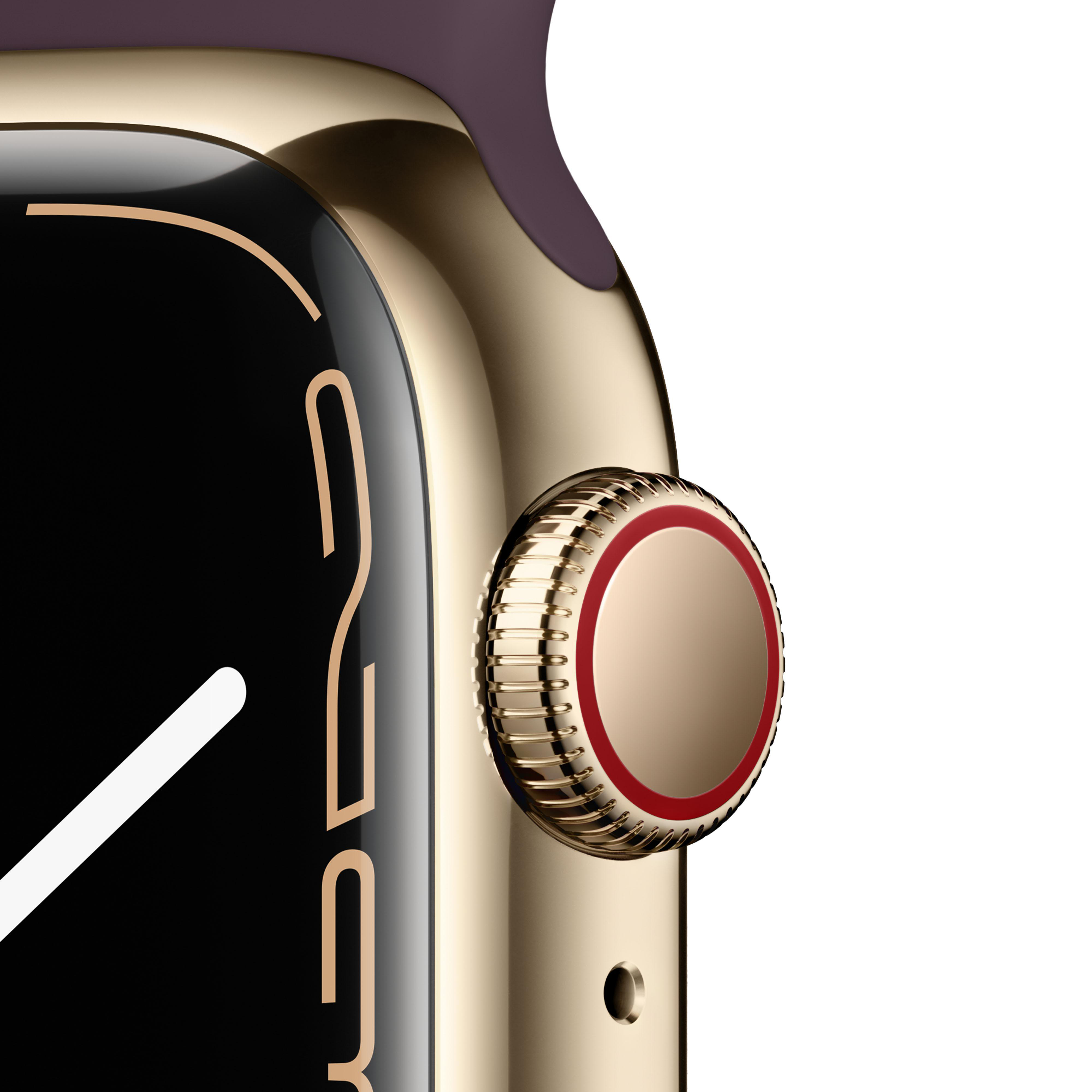 Nahaufnahme einer goldenen Apple Watch mit rot umrandeter Krone und dunkelviolettem Armband.