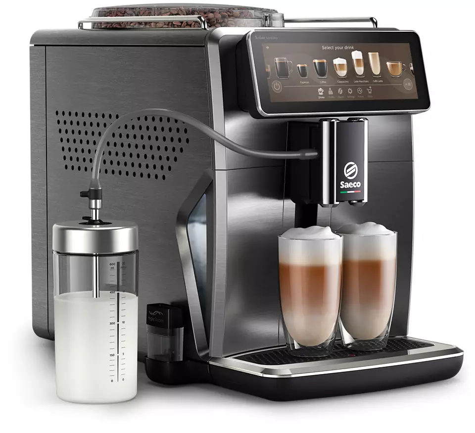 Coffee machine with two glasses of latte and a milk container. The machine is grey.