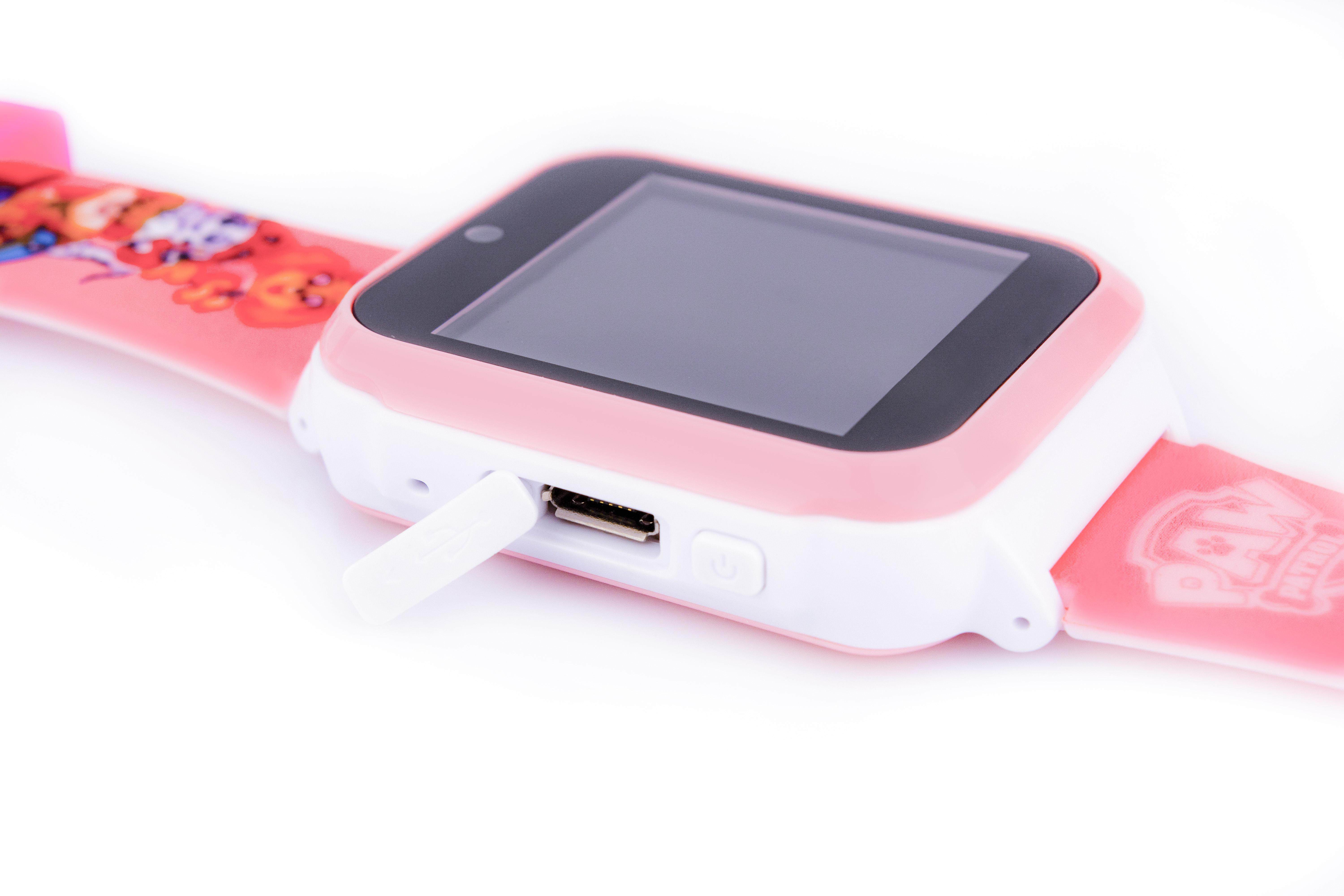 Rosa-weiße Smartwatch mit Paw Patrol-Design und geöffnetem USB-Anschluss.