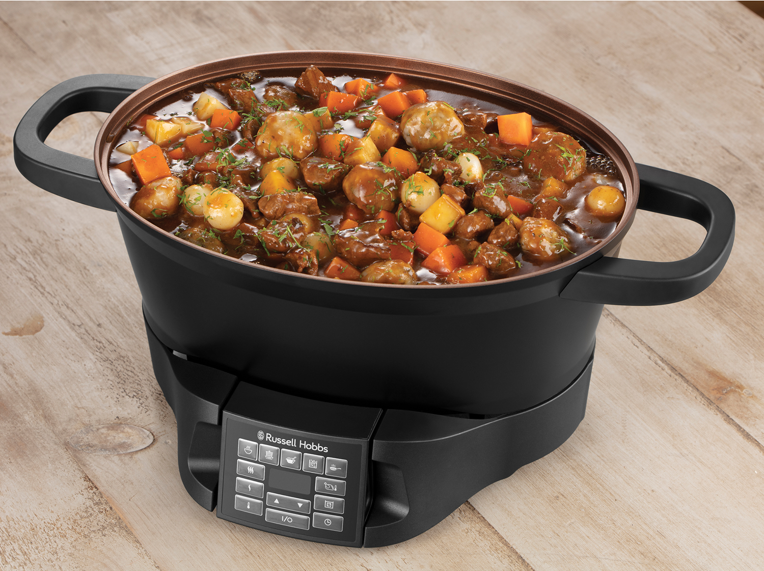 Black cooking pot with cooked stew on a black base with a digital display.