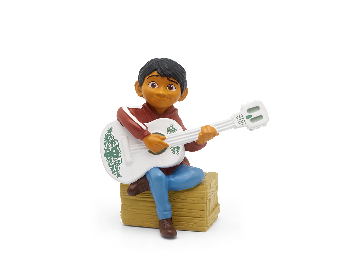 Animierter Charakter Miguel spielt Gitarre. Er sitzt auf einer Kiste.