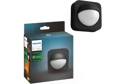 Philips Hue outdoor sensor and its box against a wooden background.