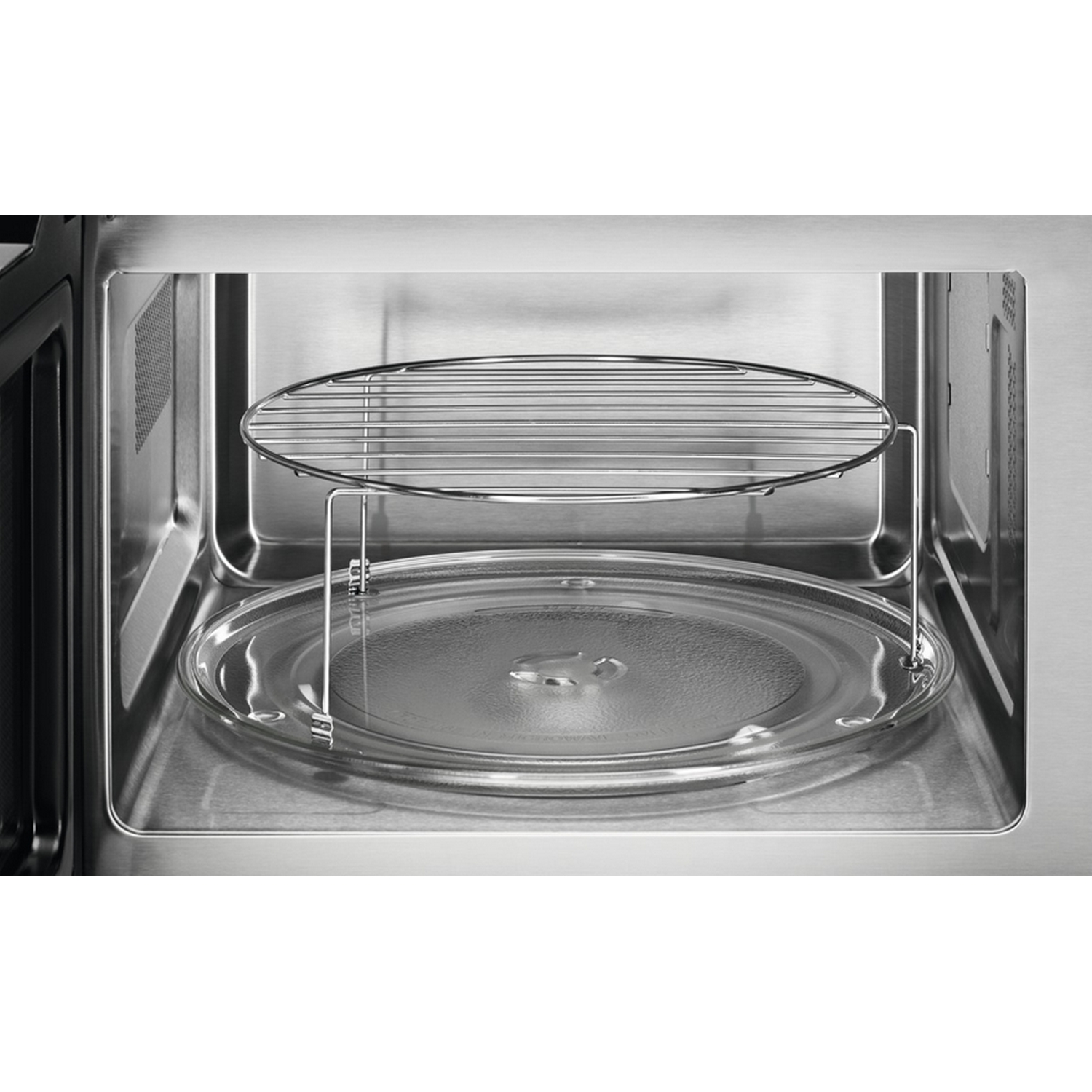 Interior de microondas con plato de vidrio y rejilla metálica en cavidad acero inox.