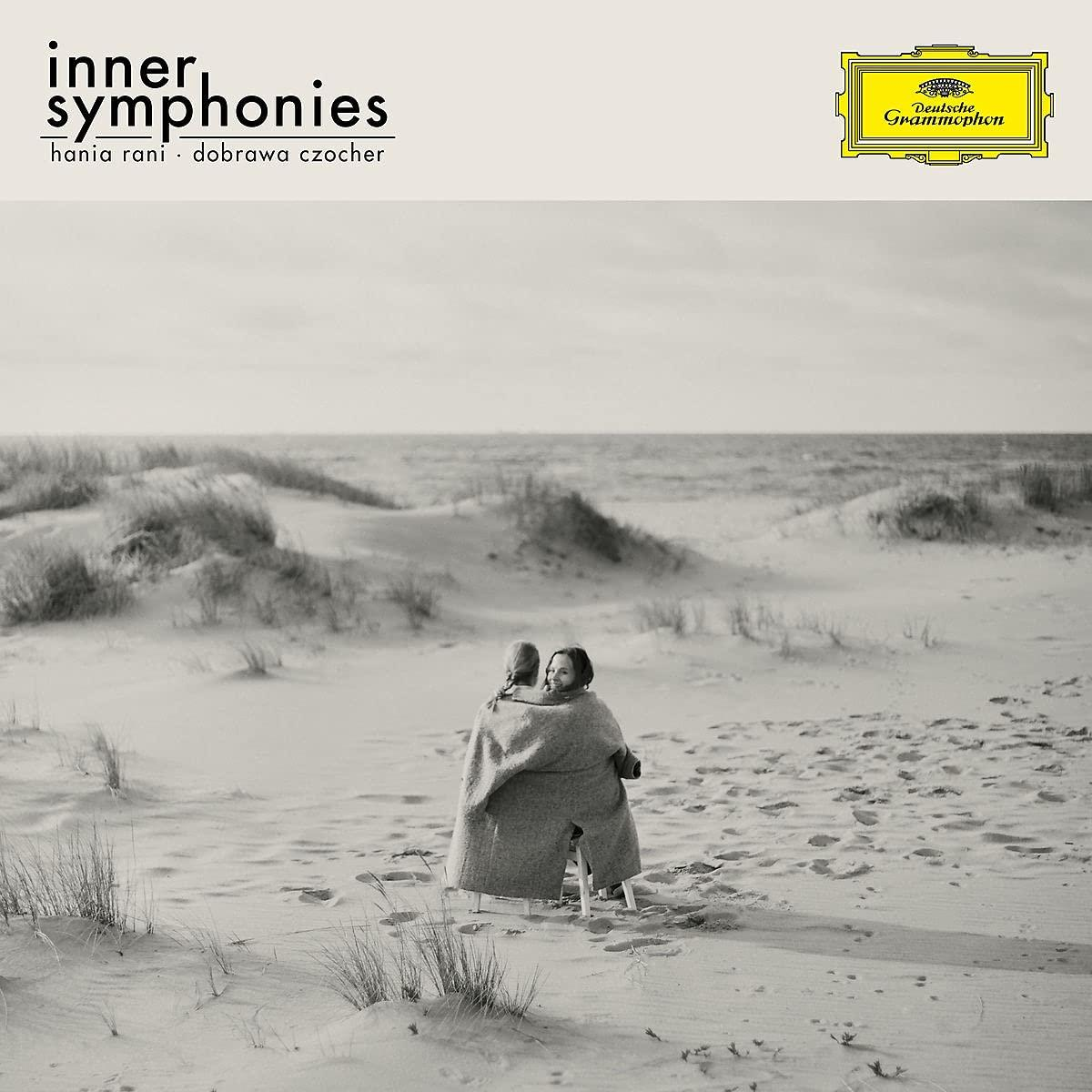 Albumcover mit zwei Personen am Strand, Titel 'Inner Symphonies'.