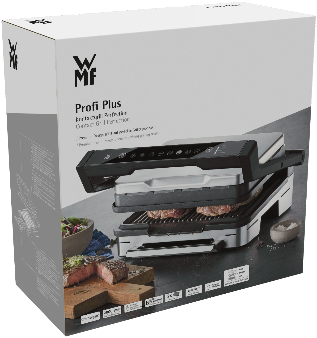 Eine WMF Profi Plus Grillbox mit Grill im Inneren und Essen vorne.