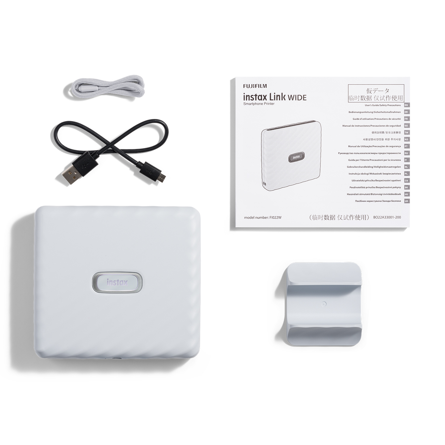Stampante per smartphone Instax Link Wide bianca con accessori e manuale utente.
