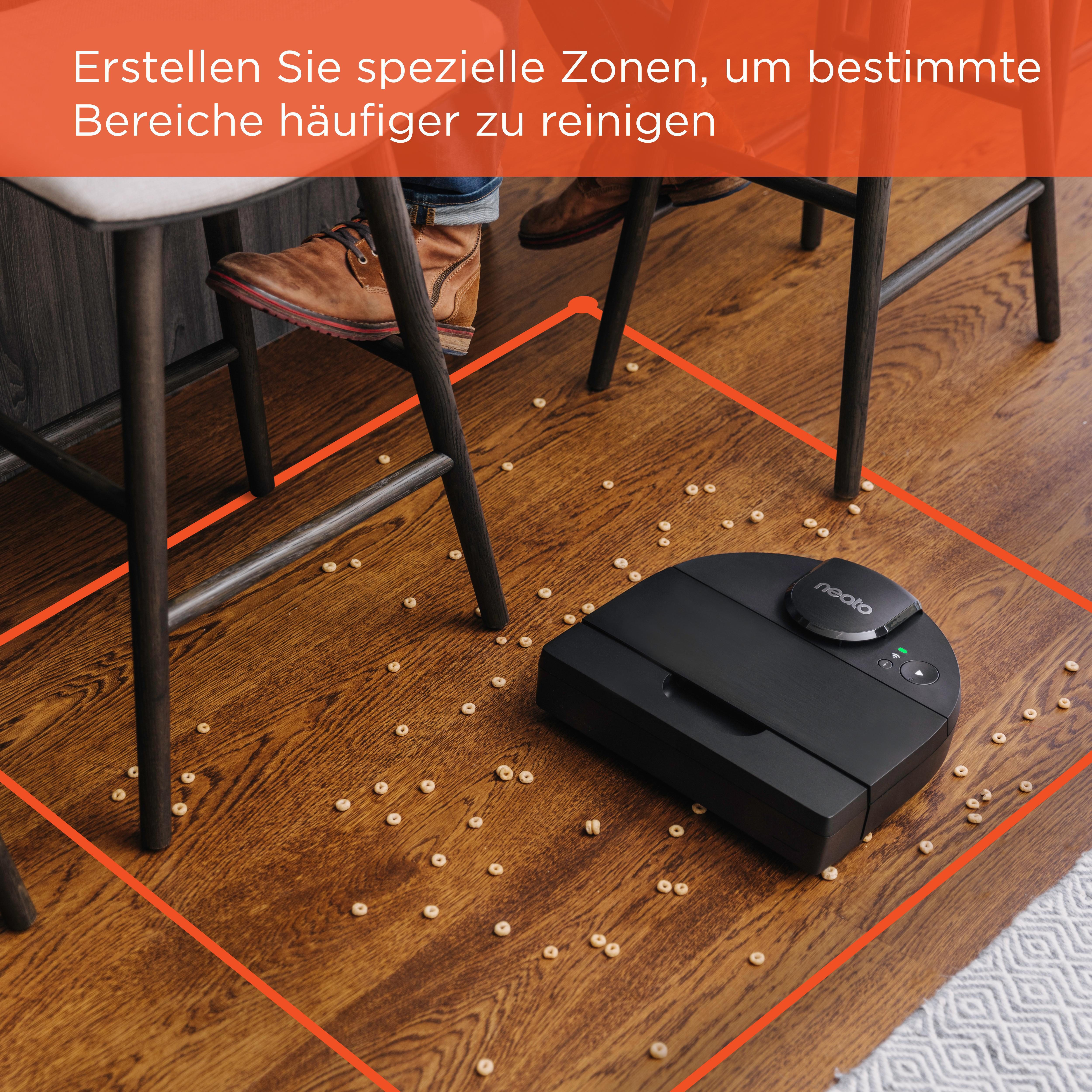 Schwarzer Roboter-Staubsauger auf Holzboden mit verstreutem Essen, umrahmt von roter Linie.