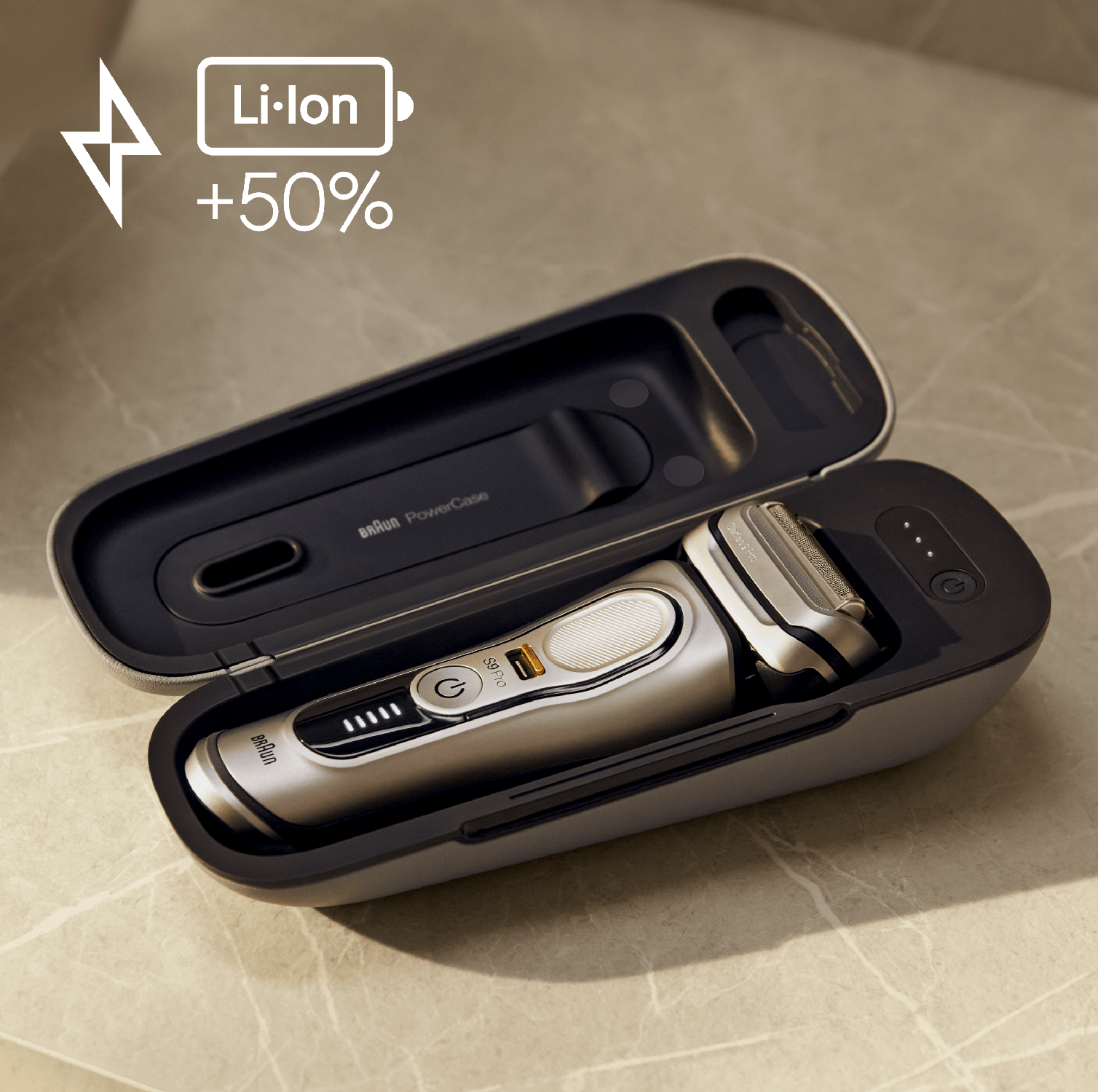 Silver Braun electric shaver in a case. The case is open, showing the shaver and a charging port.