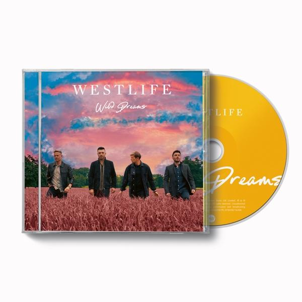 Boîtier CD 'Wild Dreams' de Westlife avec un disque. Les membres du groupe sont dans un champ.